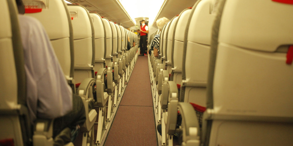 Row of empty grey seats in an airplane cabin
