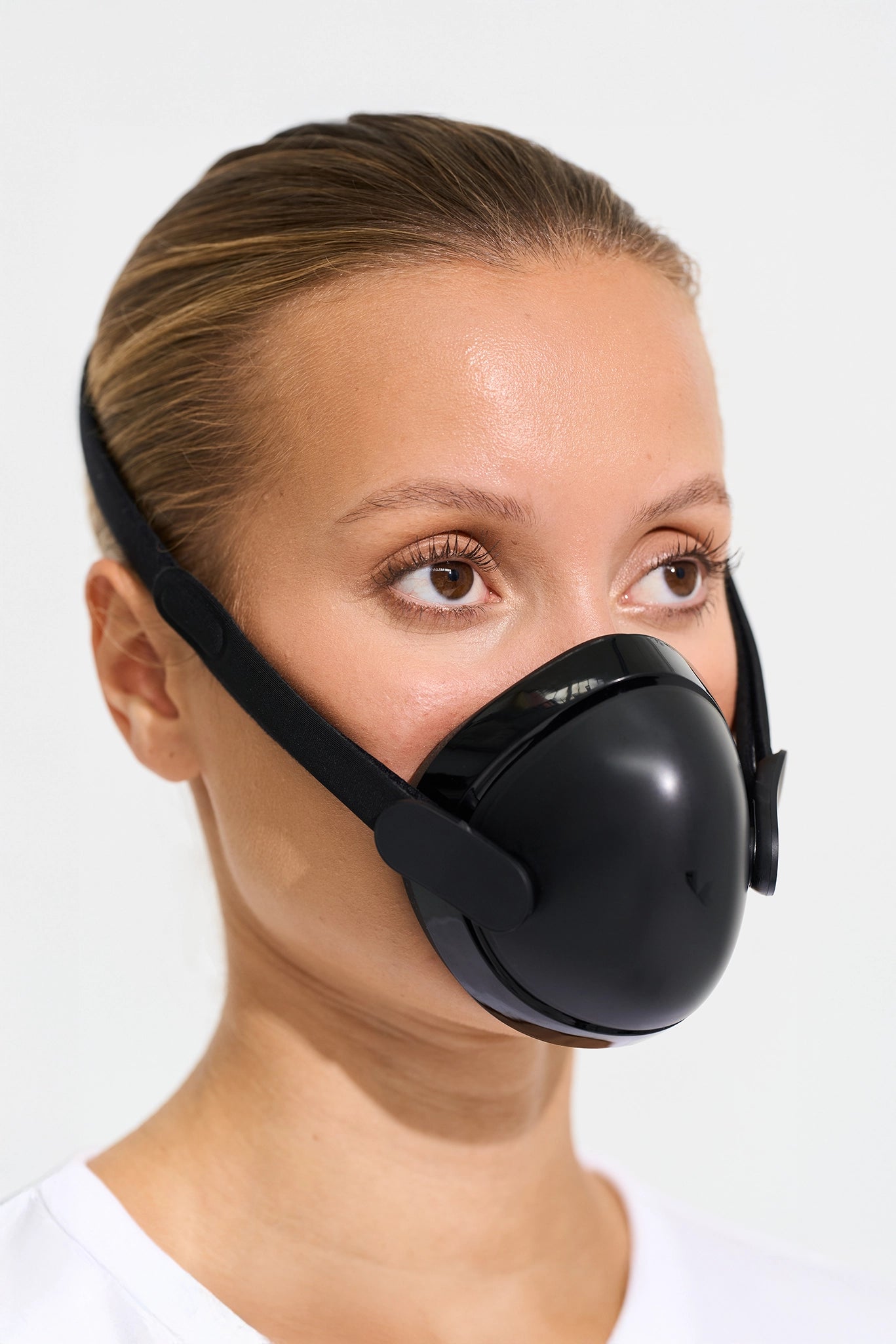 woman wearing a humidifier face mask on a white background