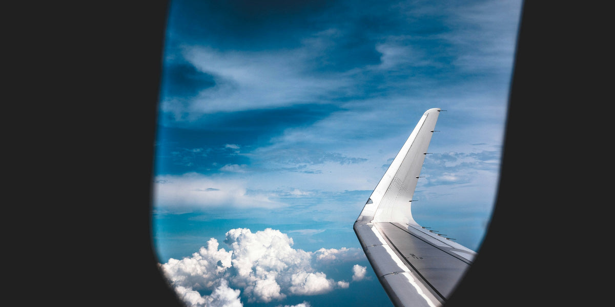 View of clouds through a gray airplane cabin window