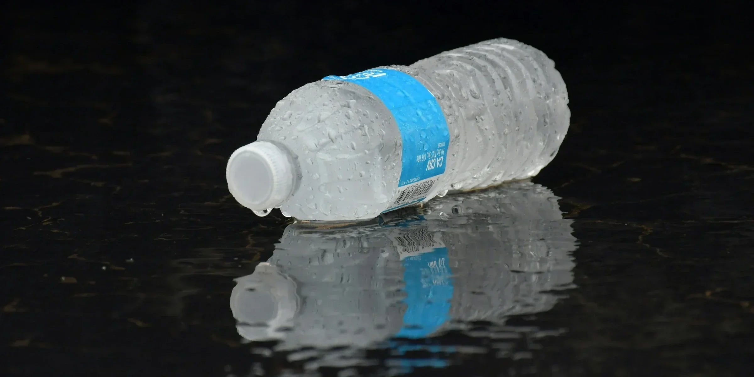 Water bottle on a plain background, the drink performers reach for before going on stage